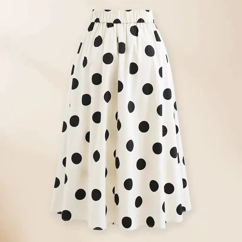 Women's black one-piece swimsuit with attached white skirt-style beach dress and a bow detail.