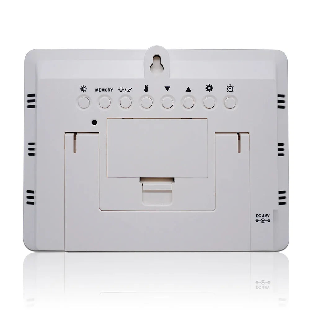 Rectangular black digital weather station clock with LCD display showing time, temperature, humidity, and forecast.