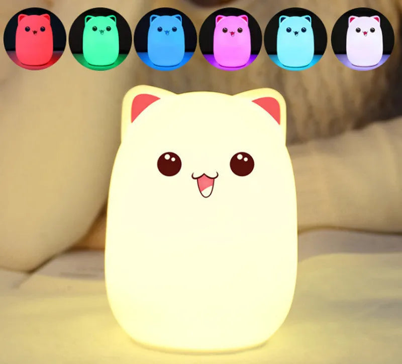 Cartoon silicone clap lamp in blue with warm white light mode on a wooden bedside table