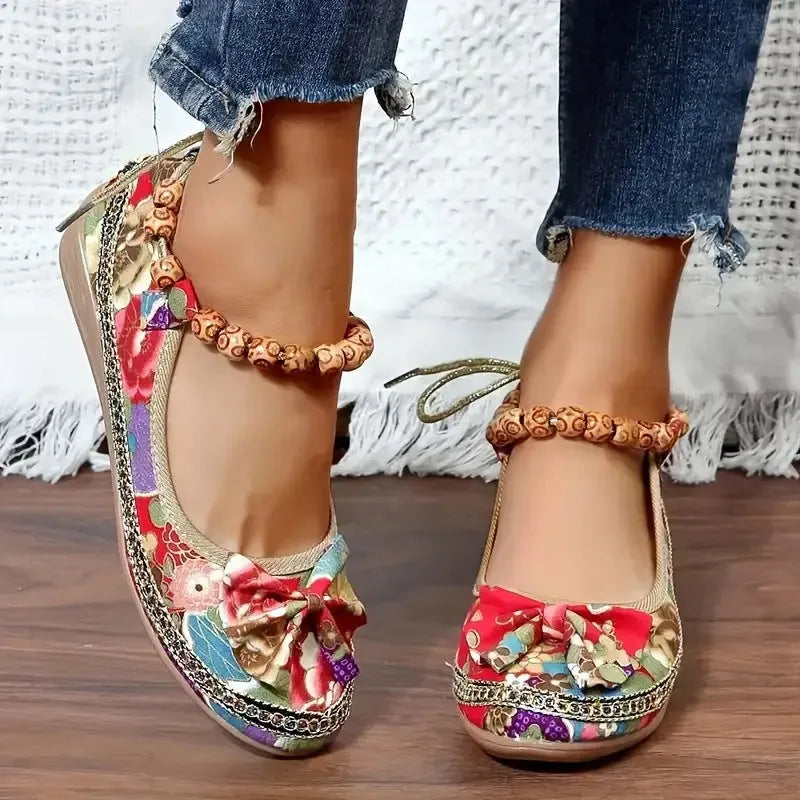 Women's black ethnic platform sandals with cloth upper and elastic band fastening on a white background.
