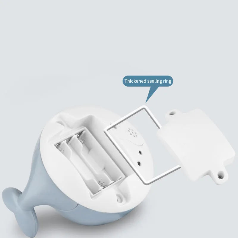 Electric whale bath toy with automatic water spray and flashing lights on a base