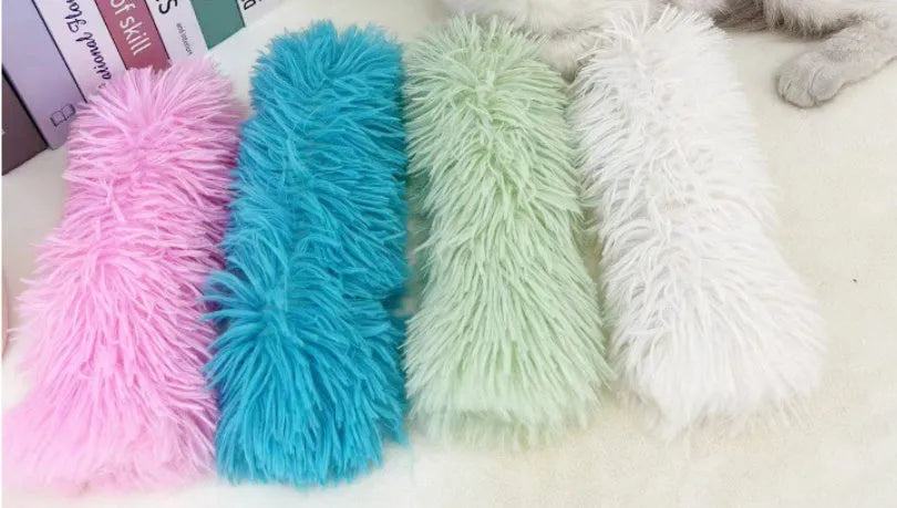 Plush cat toy pillow in blue, green, pink, or white colours, measuring 27cm by 10cm.