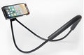 White mobile phone neck holder with 360-degree rotating clamp holding a smartphone.