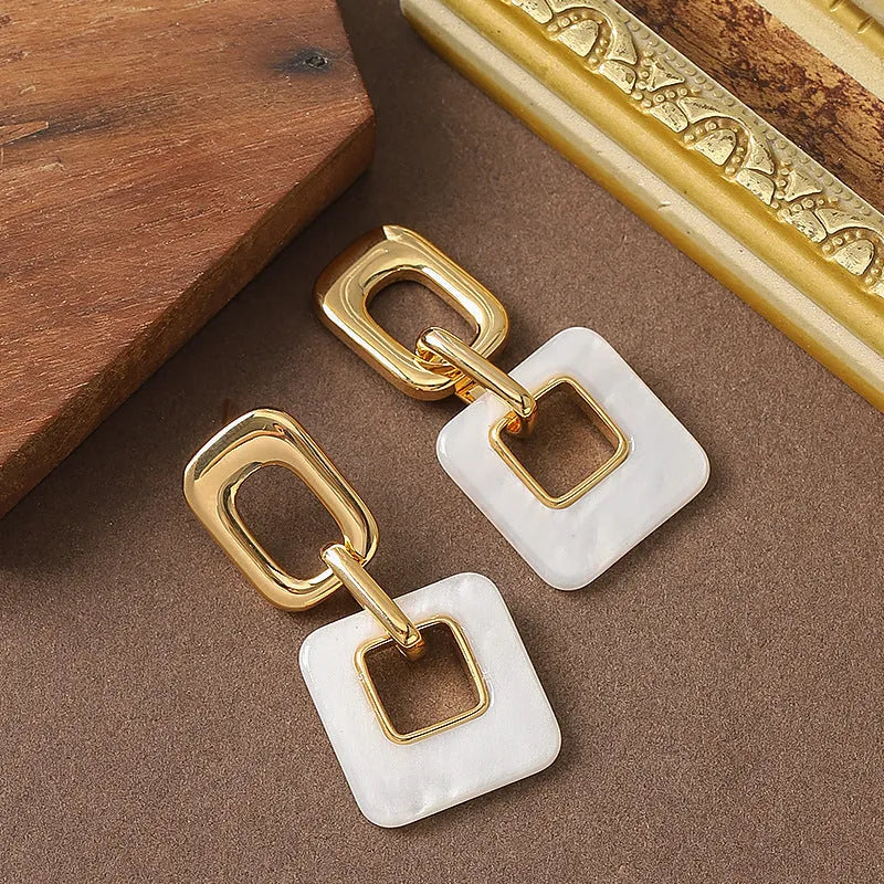 Geometric hollow square earrings with chamfered corners in electroplated copper