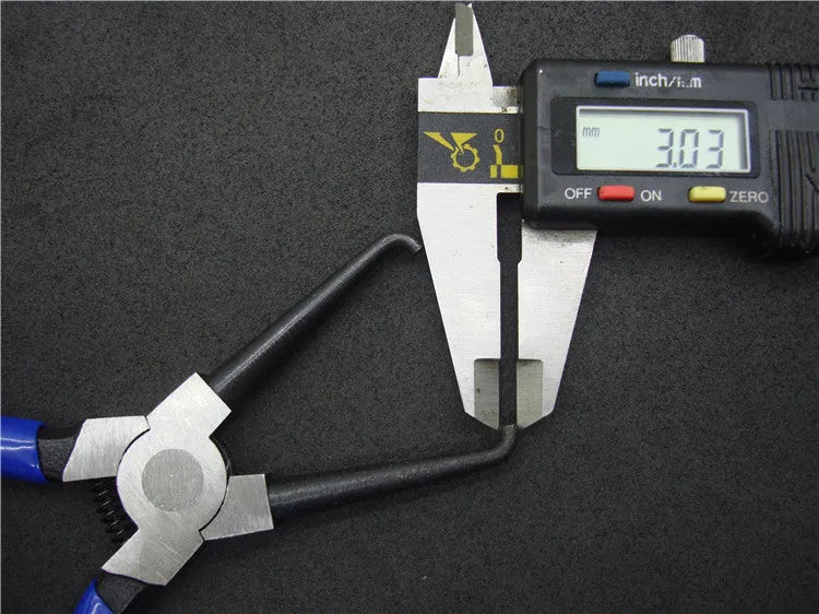 Iron and rubber caliper tubing pliers for automotive fuel line maintenance.