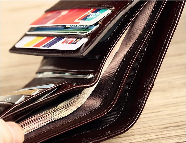 Men's leather wallet open showing photo window, card slots, coin pocket, and banknote compartment.