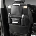 Black leather car seat back storage bag hanging on a vehicle seat.