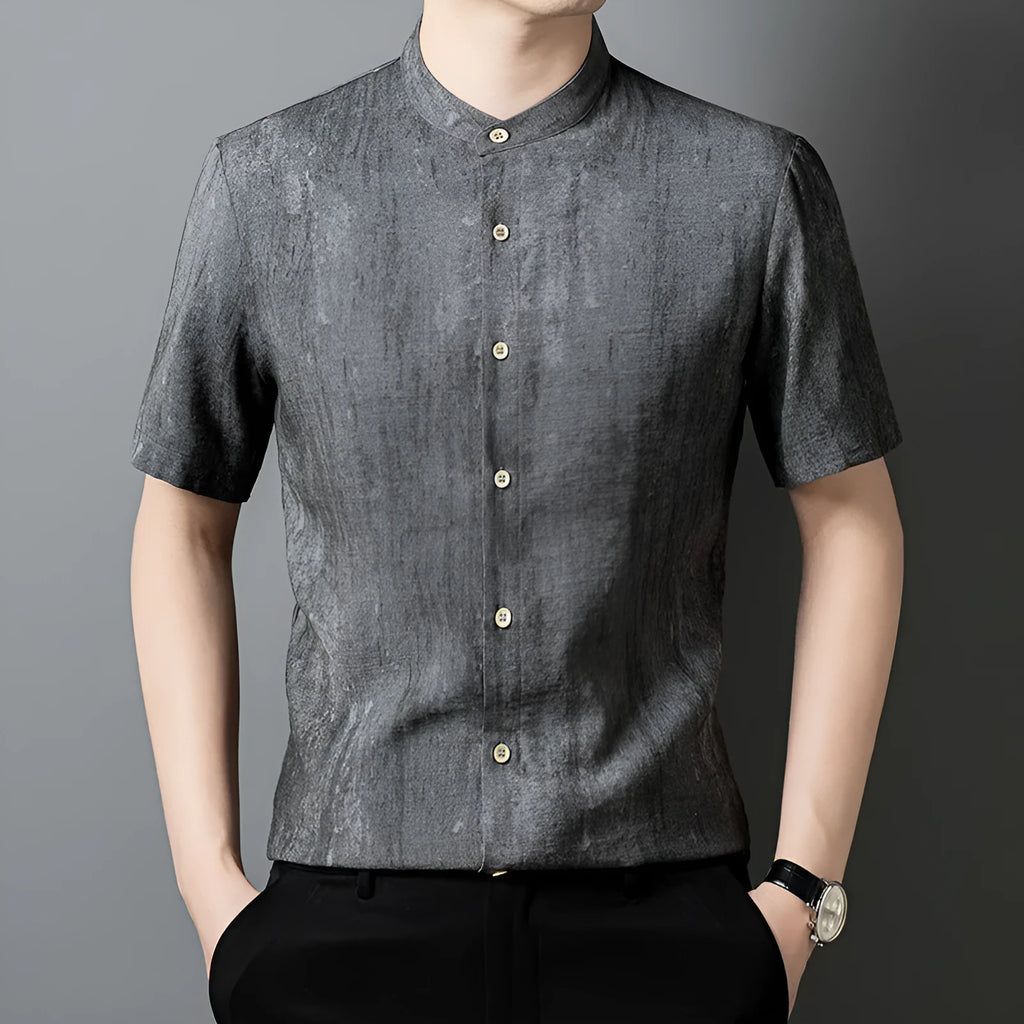 Men's loose grey linen shirt with stand collar, cardigan style, on a hanger.