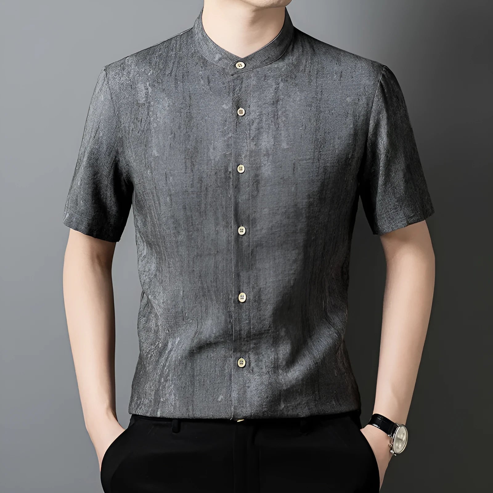 Men's loose grey linen shirt with stand collar, cardigan style, on a hanger.