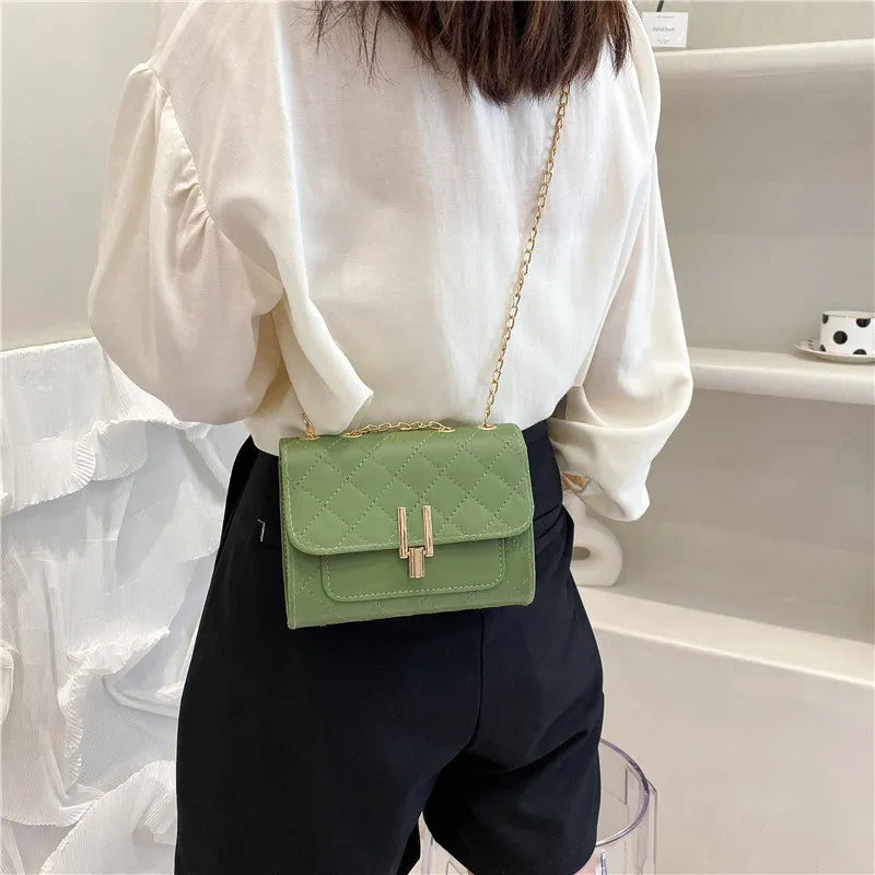 Women's minimalist crossbody bag with diamond lattice chain detail in black, white or green
