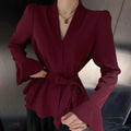 Women's black French-style shirt with irregular collar and tied waist detail featuring bell sleeves