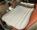 Black inflatable car bed with flocked surface, two pillows, and storage bag for five-seater vehicles
