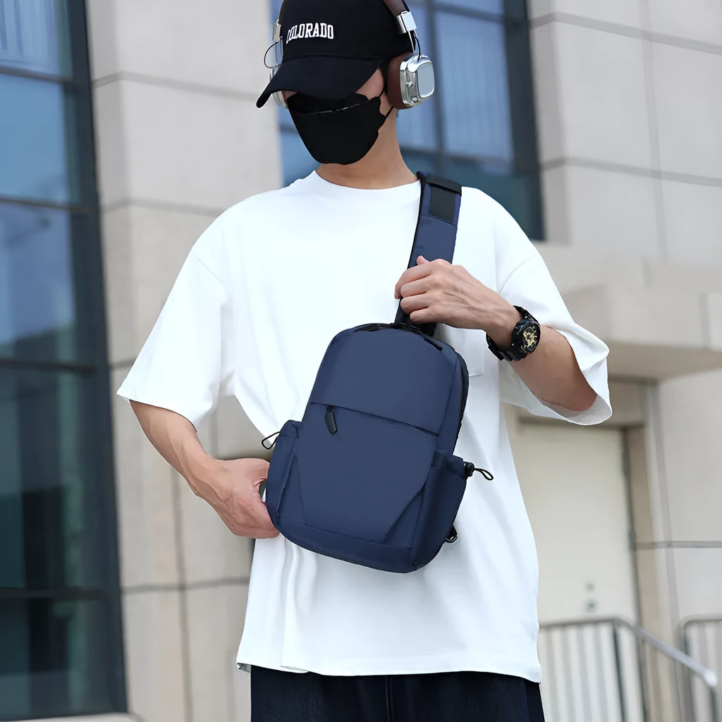 Men's grey waterproof chest bag with adjustable shoulder strap showing front compartment