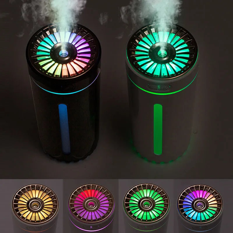 Compact black wireless humidifier with colourful LED lights sitting in car cup holder