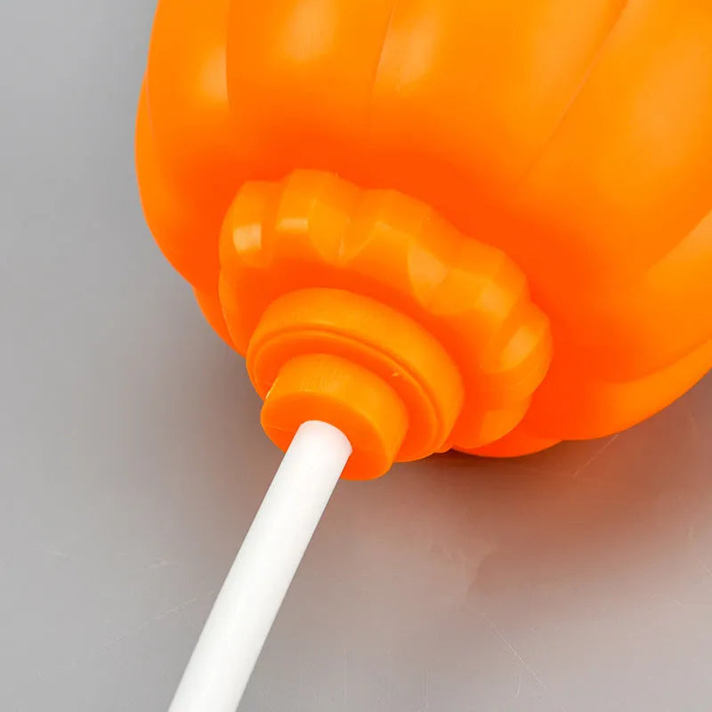 Plastic pumpkin-shaped decorative lamp with purple or yellow light, standing 22cm tall.