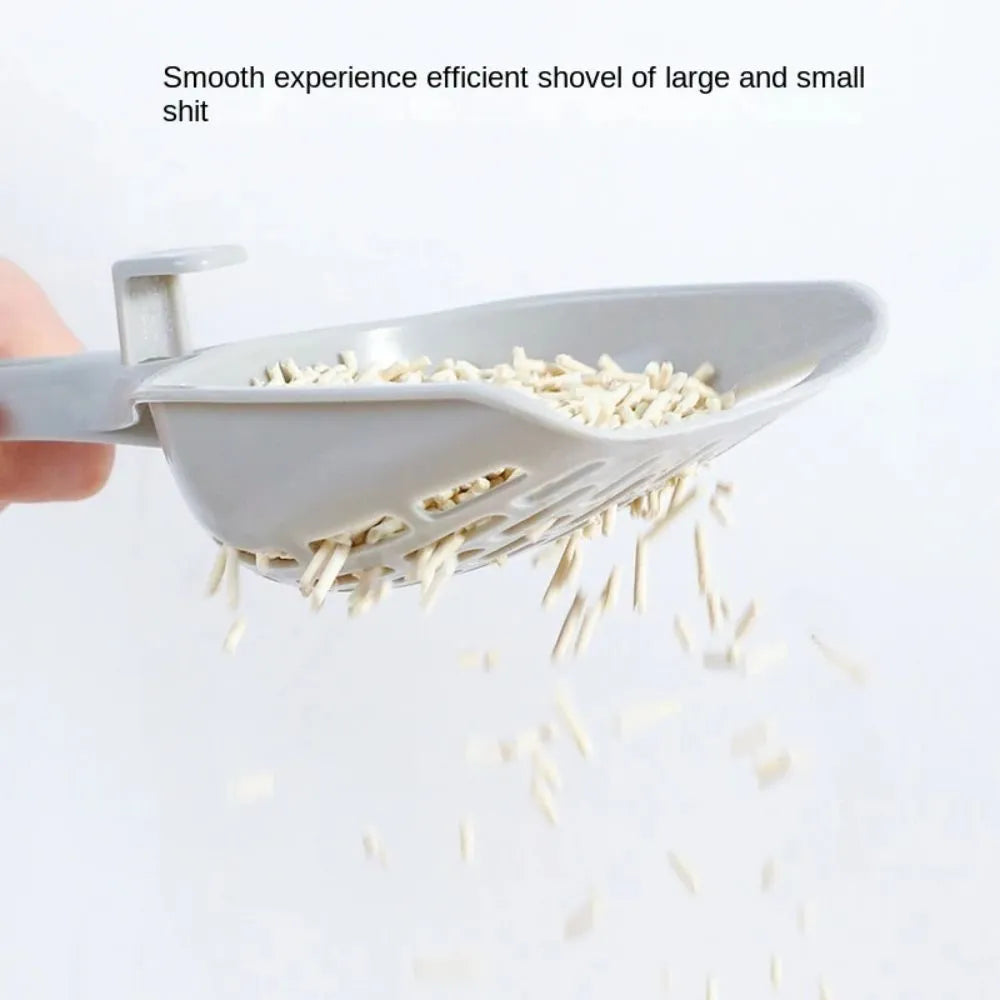 Grey plastic cat litter scoop with perforations, shown sitting on its attached square base stand.