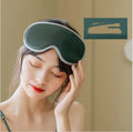 Pink and green portable eye SPA mask with USB cable, showing suede exterior and super fibre interior.