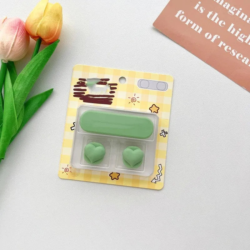 Cartoon magnetic protection data cable fixer in assorted colours on a desktop.