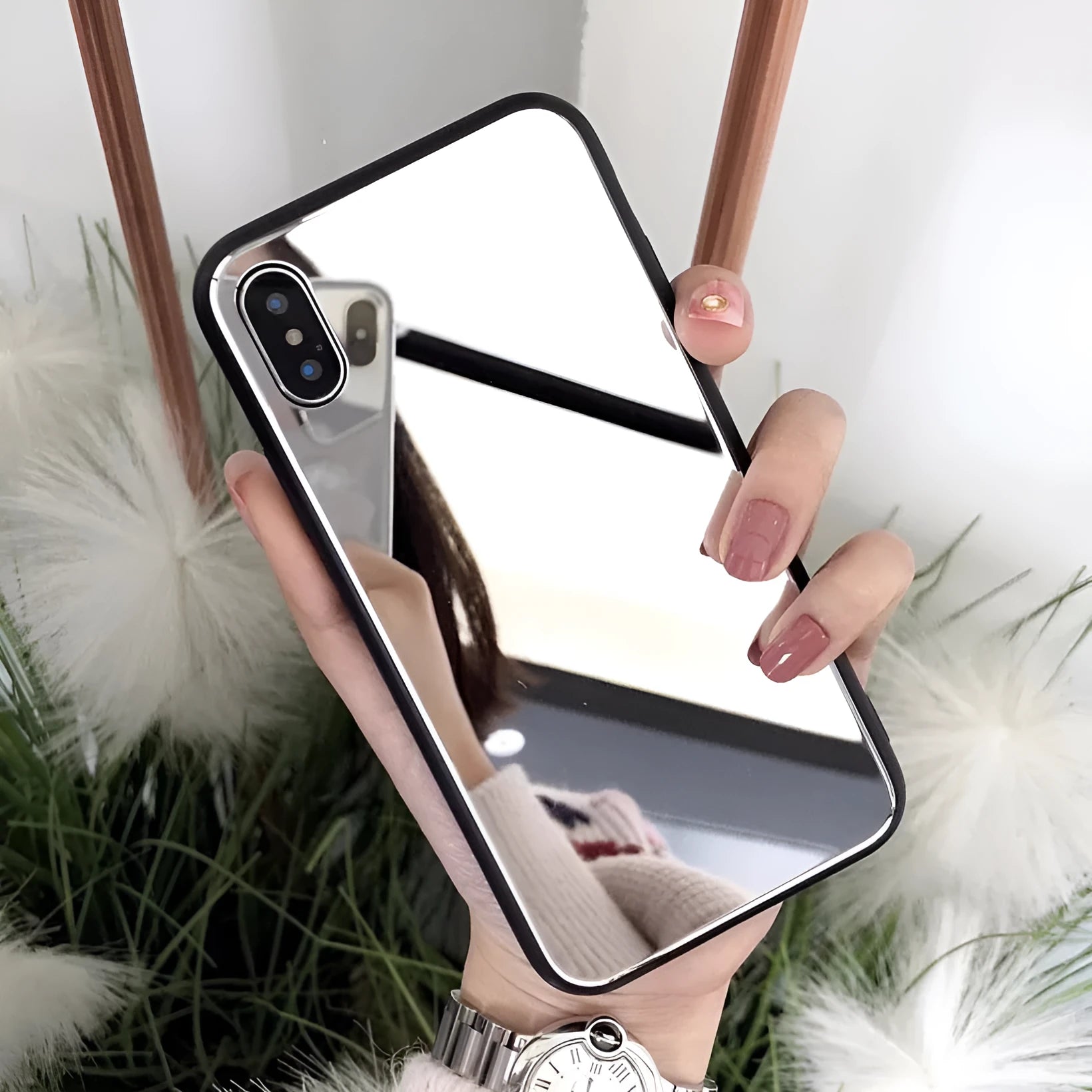 Black iPhone mirror phone case showing reflective surface on back, compatible with iPhone X and other models.