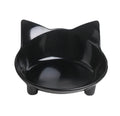 Set of four black shallow melamine pet bowls with non-slip rubber bases on a white surface.