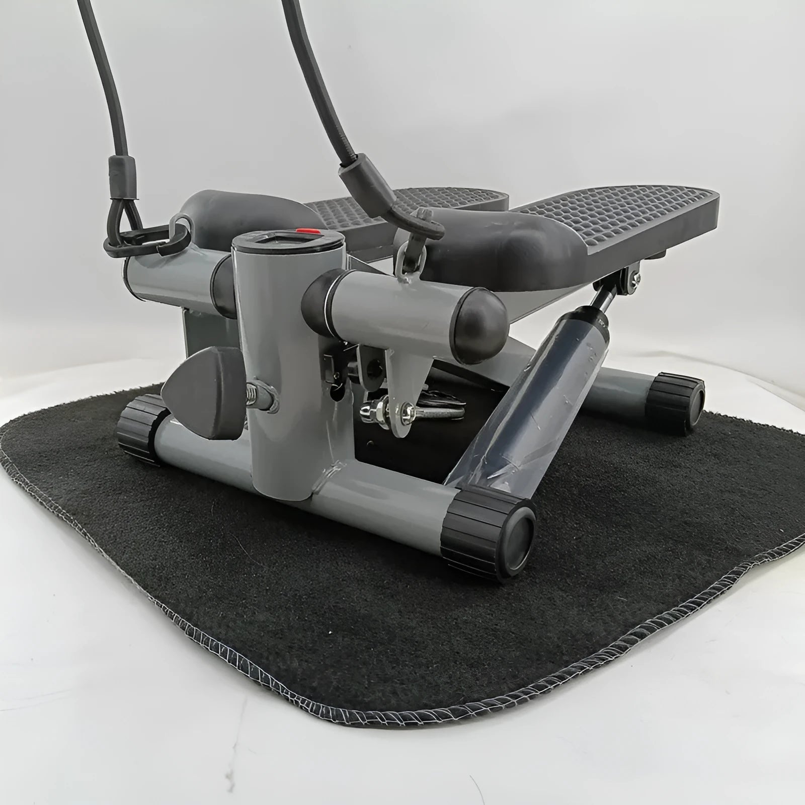 Silver grey mini treadmill waist slimming machine with hydraulic resistance and pedals.