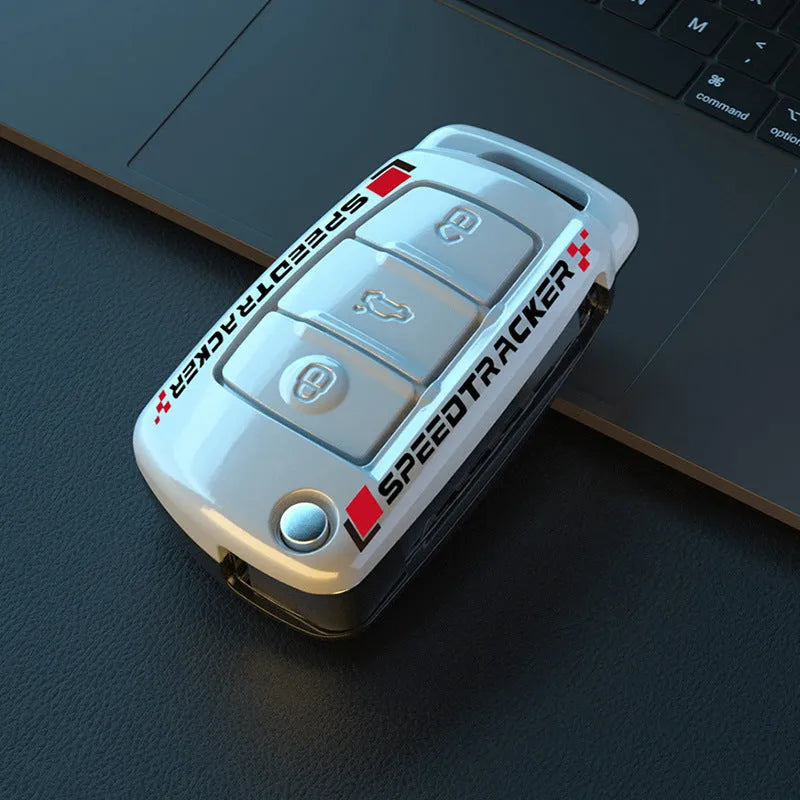 Carbon fibre pattern car key cover with a small rectangular mirror set into the feilin material casing.