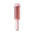 Blue reusable pet hair removal roller with a self-cleaning base on a fabric sofa.