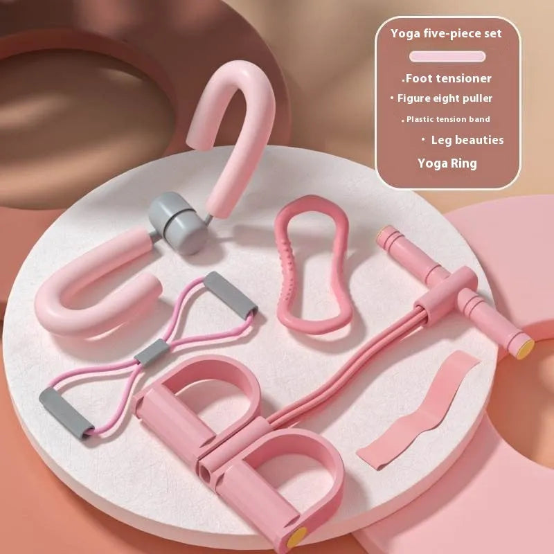 Yoga four-piece fitness set showing leg stretcher, ring, pedal device, and tension rope on a floor.