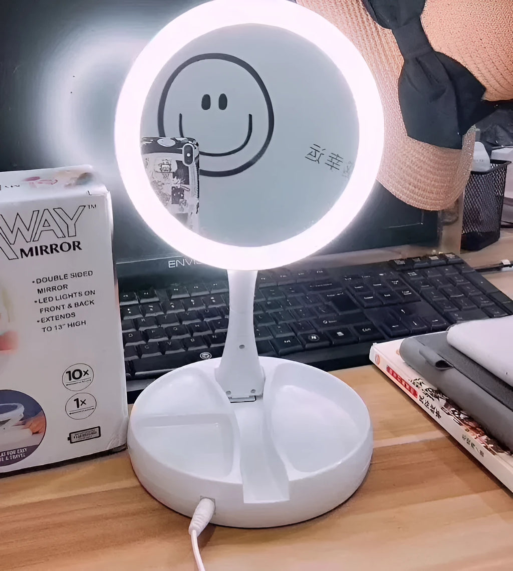 White foldable LED vanity mirror with USB charging port and double-sided storage compartment open on dressing table