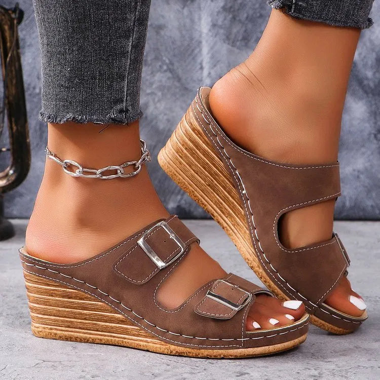 Women's creamy-white wedge buckle slippers with PU upper and rubber sole on a plain background.