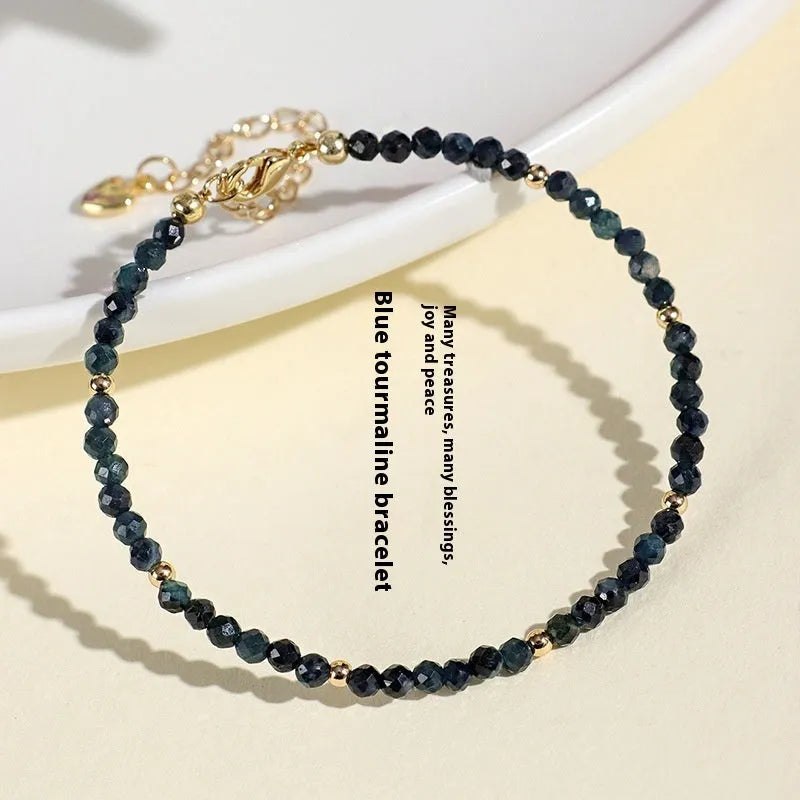 Blue tourmaline beaded bracelet with silver spacer beads and adjustable clasp