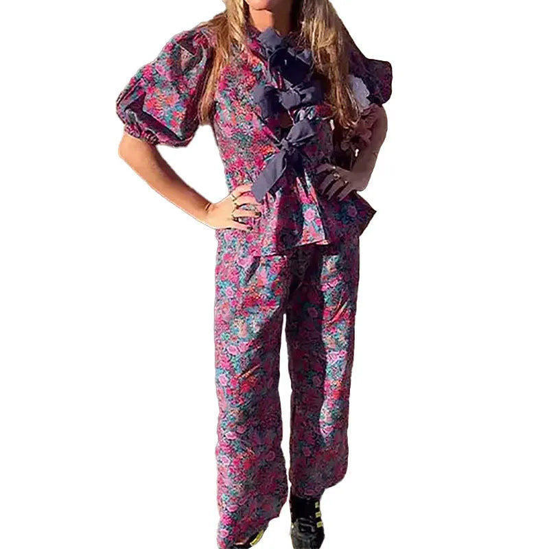 Floral printed tie-neck blouse and trousers suit set with puff sleeves.