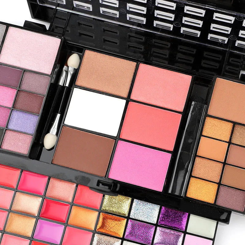 74 colour makeup palette open showing eyeshadows, lip glosses, and face powders with brushes