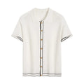 White women's short sleeve cardigan with dark contrast lapels on a hanger.