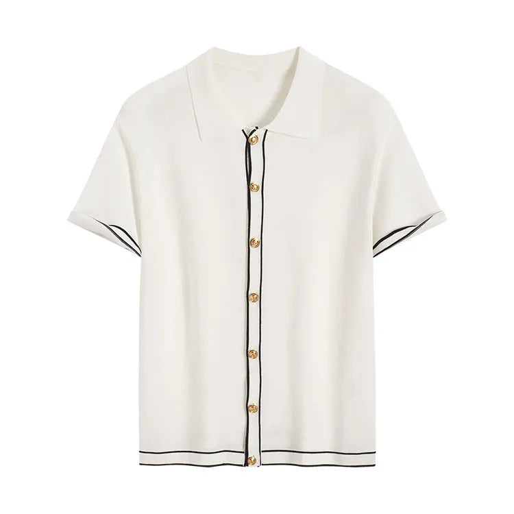 White women's short sleeve cardigan with dark contrast lapels on a hanger.