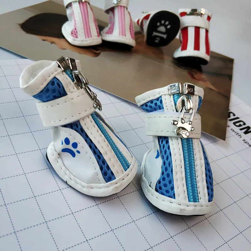 Set of four blue cloth dog shoes with zipper fastening and non-slip soles for small pets.