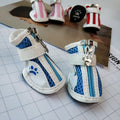 Set of four blue cloth dog shoes with zipper fastening and non-slip soles for small pets.