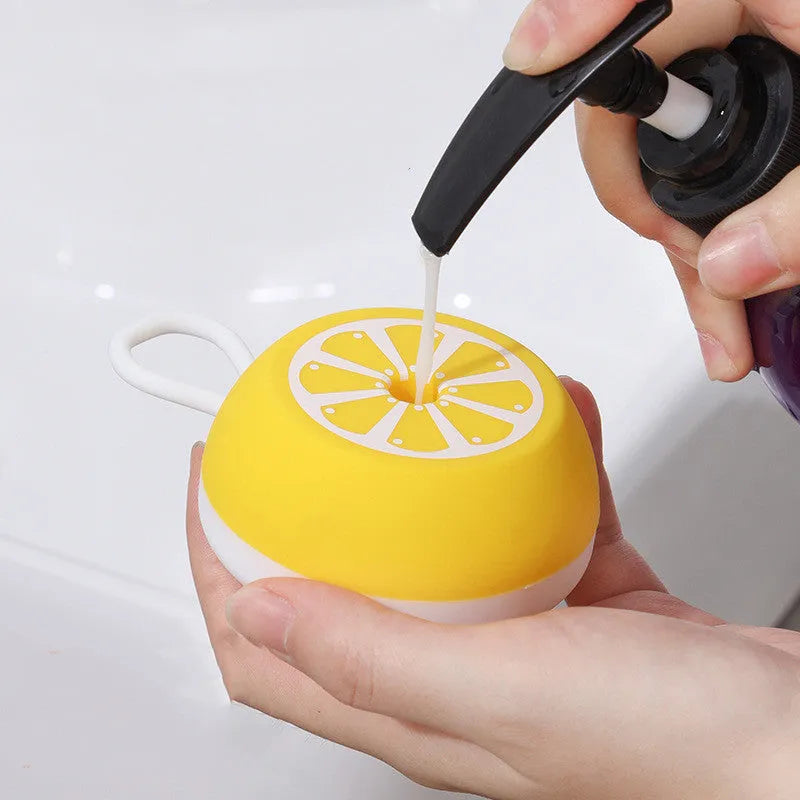 Yellow silicone pet bath brush with massage head and comb teeth for dog cat grooming during washing