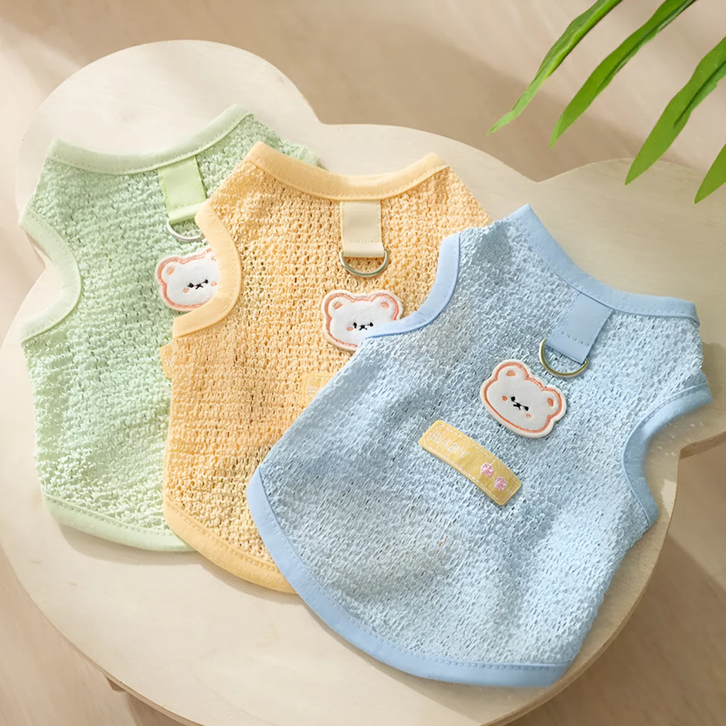 Green knitted cat clothing with a bear patch and breathable hollowed-out design on a cat model.