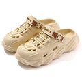Men's khaki outdoor slippers with hollow-out design and textured EVA sole, shown on a patio.