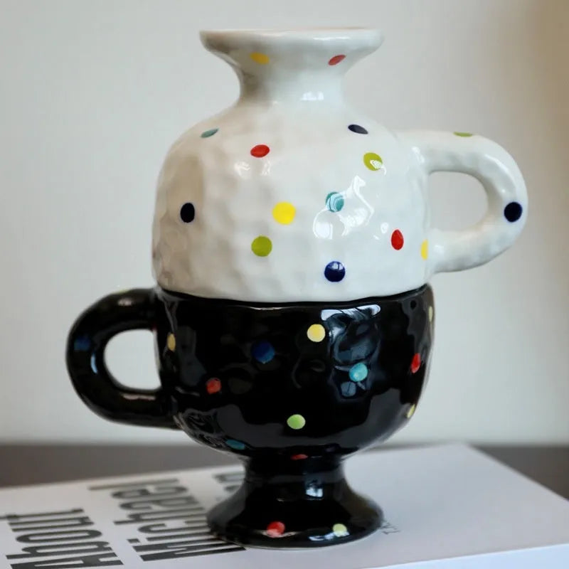 Hand-pinched irregular shaped ceramic mug in a solid colour, shown on a table.