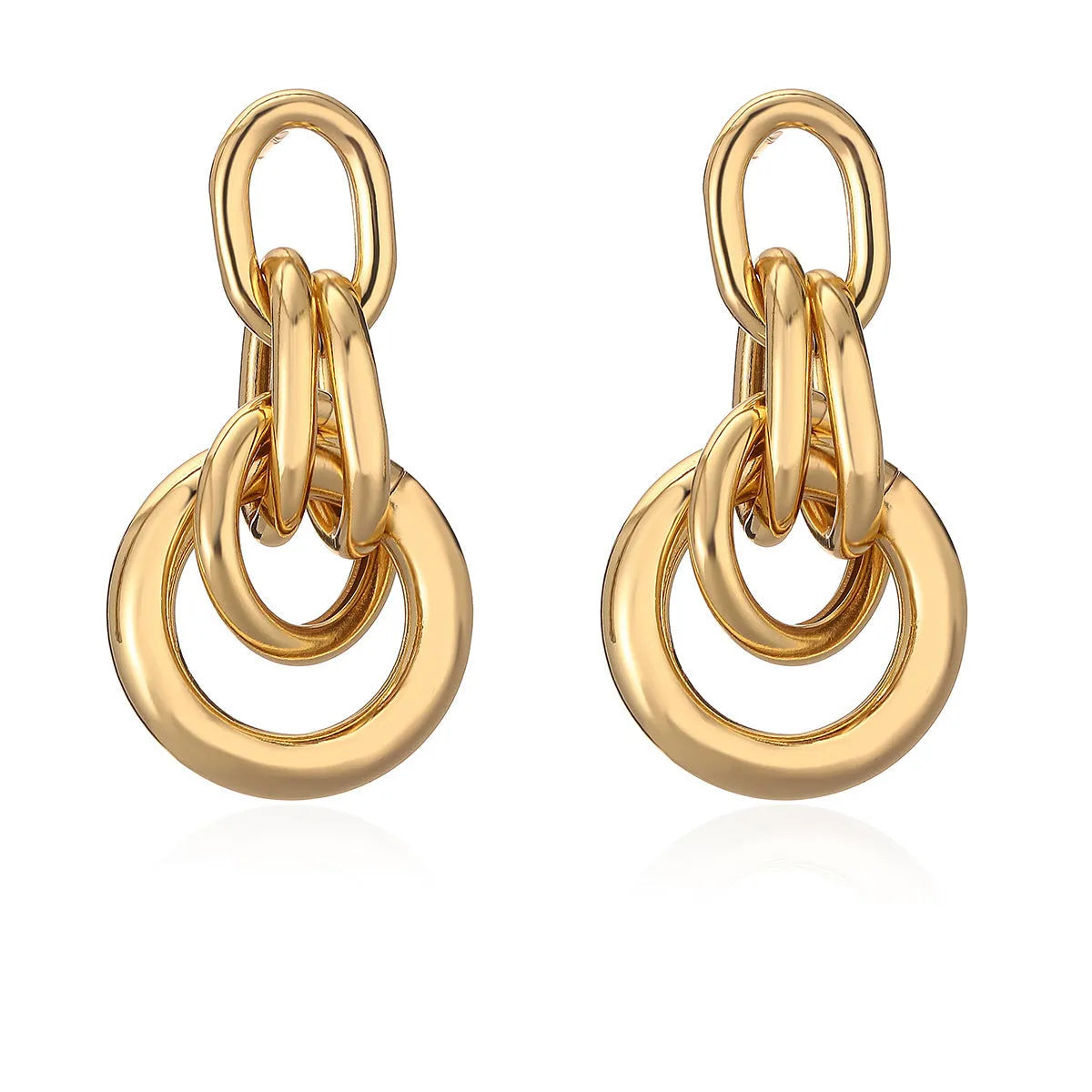 A pair of gold-colour geometric earrings with an irregular, high-profile design on a white background.