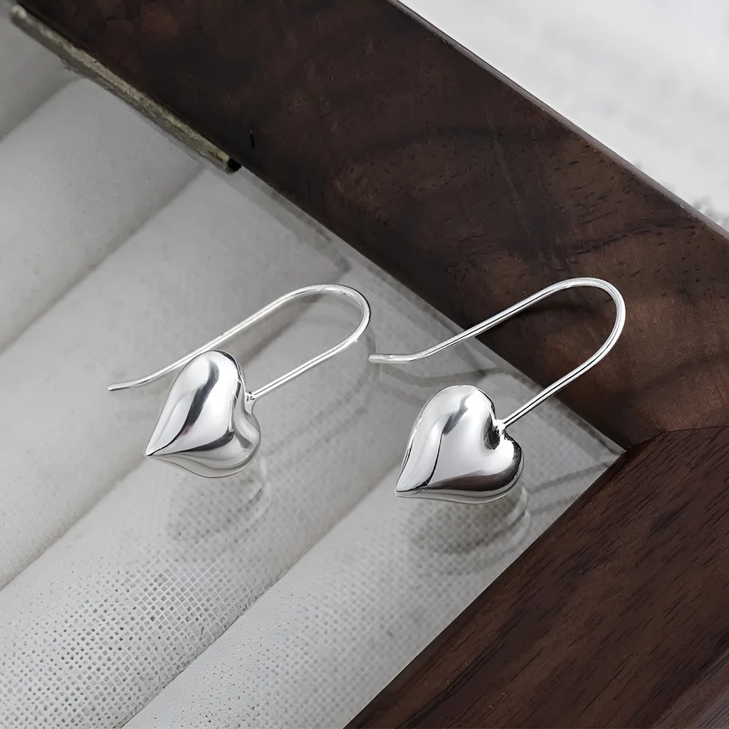 Korean style heart-shaped earrings with glossy finish and silver colour
