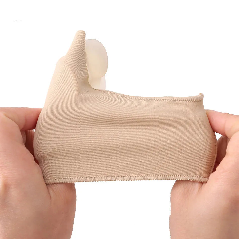 Corrective bunion relief sock with silicone gel pad and toe spacer on a foot, showing stretch fabric.