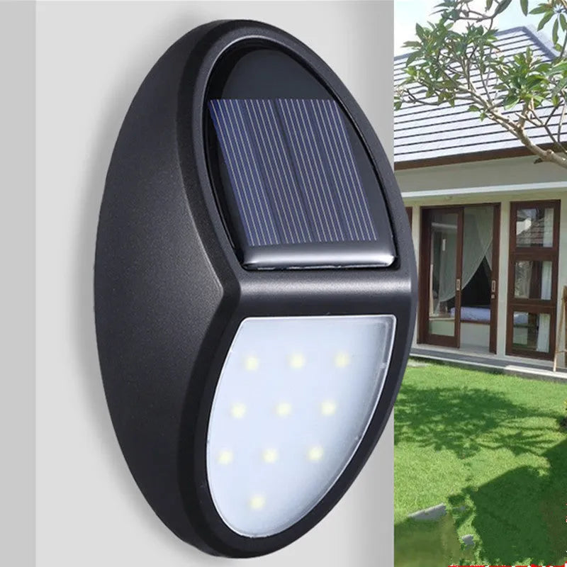 Black solar-powered LED wall light with automatic light sensor for outdoor garden use