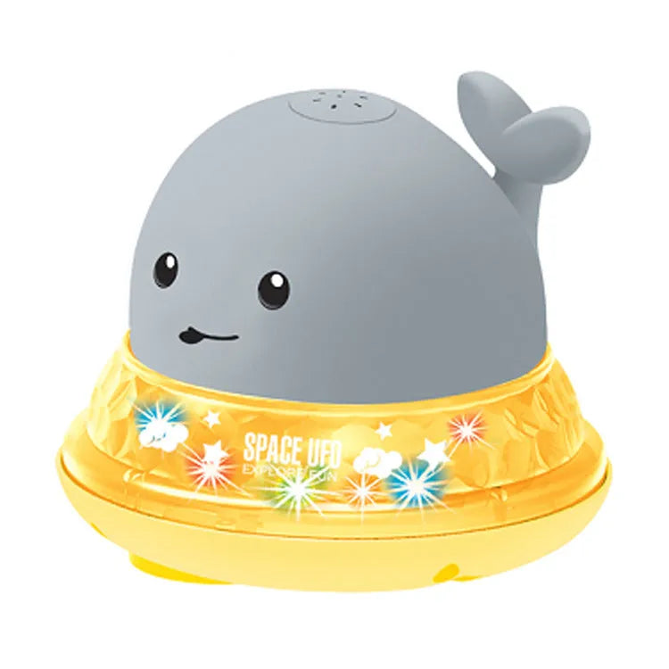 Electric whale bath toy with automatic water spray and flashing lights on a base