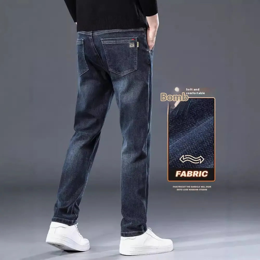 Blue grey slim straight casual trousers with a mid waist and zip fly on a neutral background.