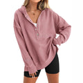 Women's loose-fitting solid colour raglan sleeve sweater in peacock green, laid flat.