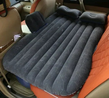 Black inflatable car bed with flocked surface, two pillows, and storage bag for five-seater vehicles