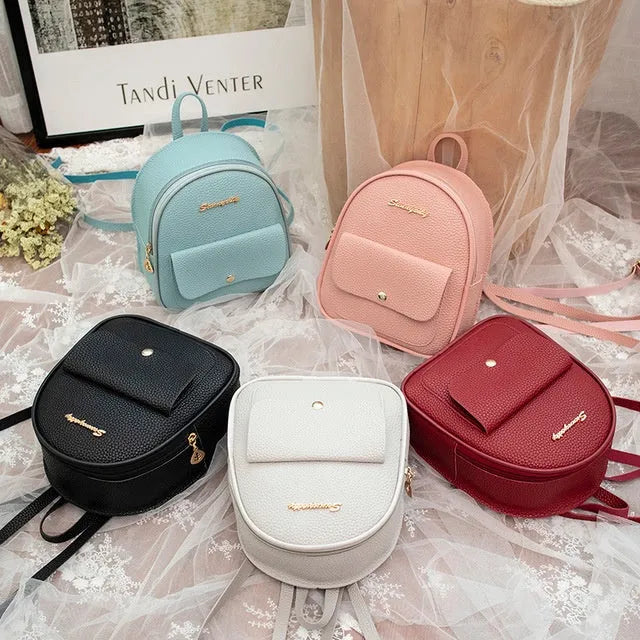 Small black PU women's backpack with zip closure shown as shoulder bag and backpack